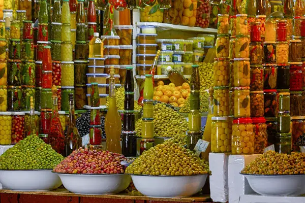 bottling fruit - marketplace piled high with exotic bottles of fruit