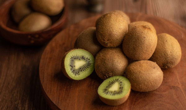 kiwi plants - kiwi fruit harvest on chopping board